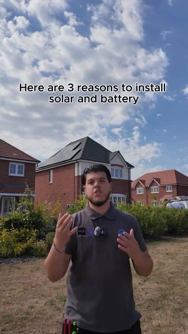 Andre in front of a new-build with a finished array, talking to camera